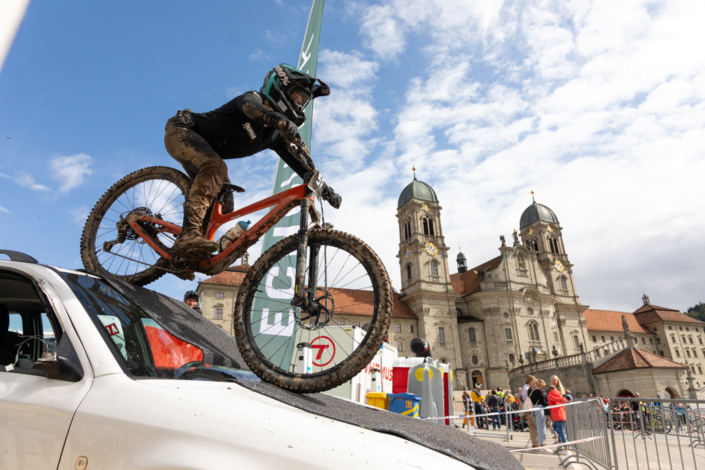 A person is riding a bicycle on the roof of a car.