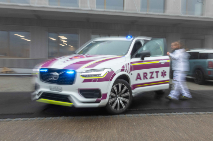 A Volvo XC90 ambulance drives along the road.