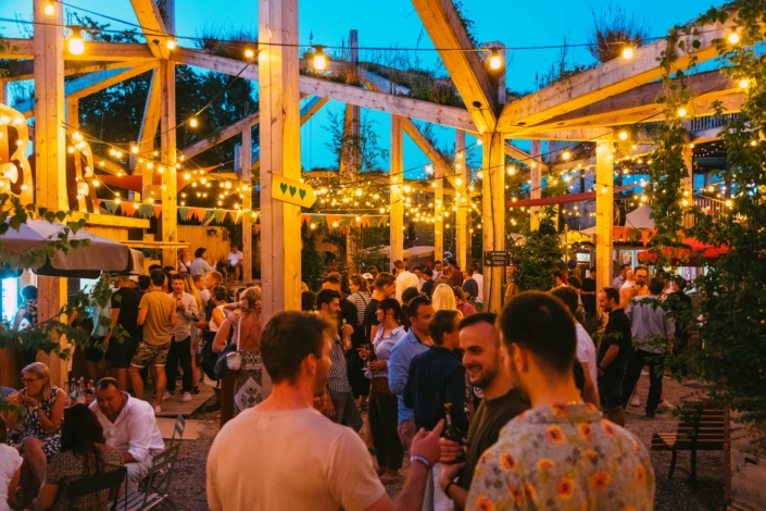 A group of people gathered in a courtyard at dusk.