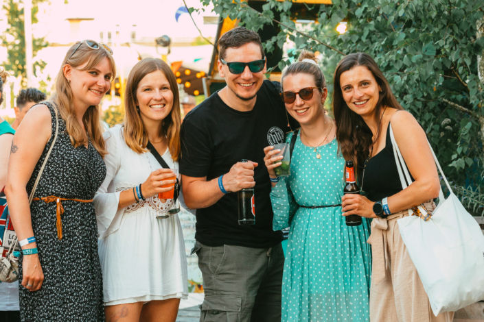 A group of people pose for a photo at an outdoor event.