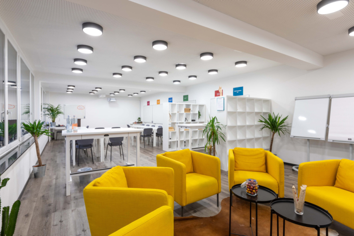 An office with yellow chairs and a table.