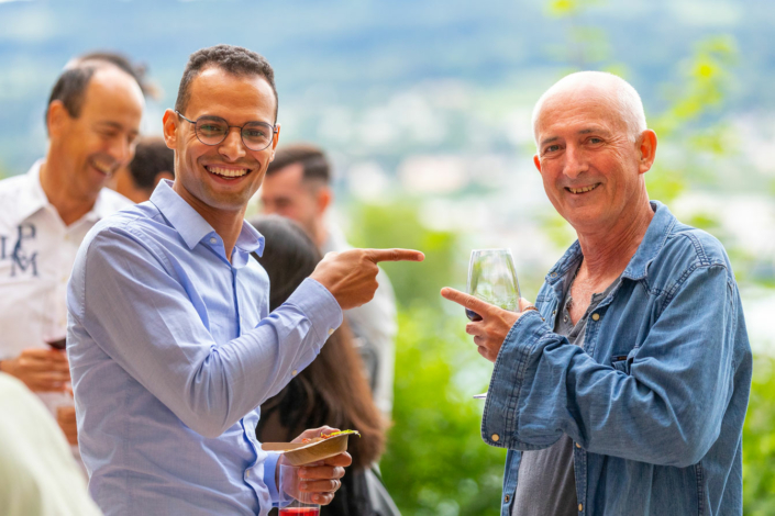 A man holds a glass of wine.