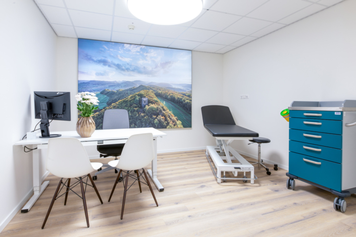 A medical room with desk and chairs.