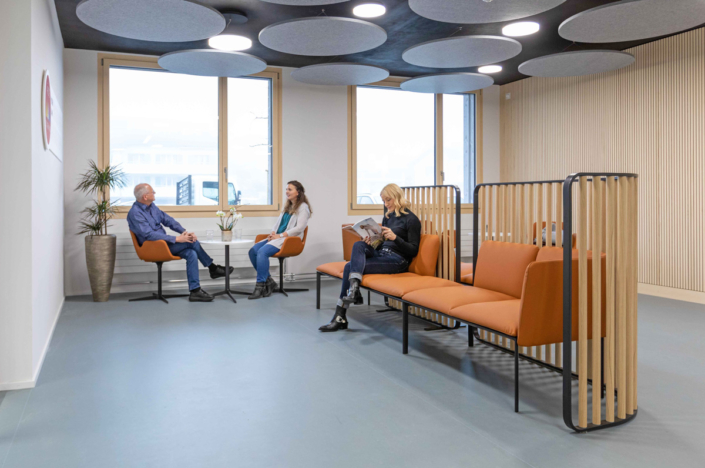 A group of people are sitting in a waiting room.